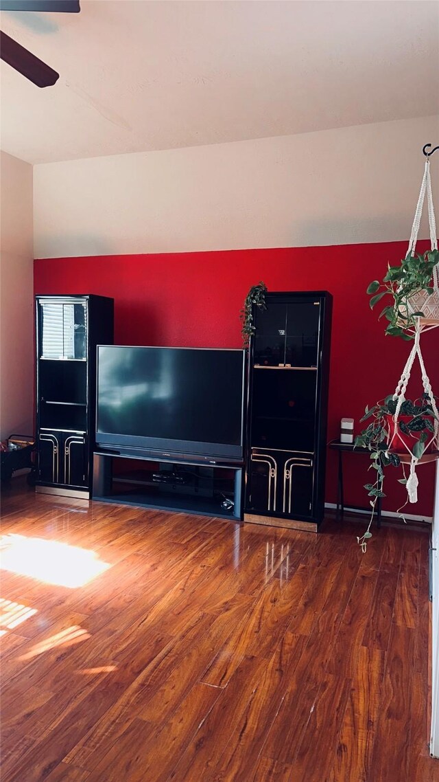 unfurnished living room with wood-type flooring and ceiling fan