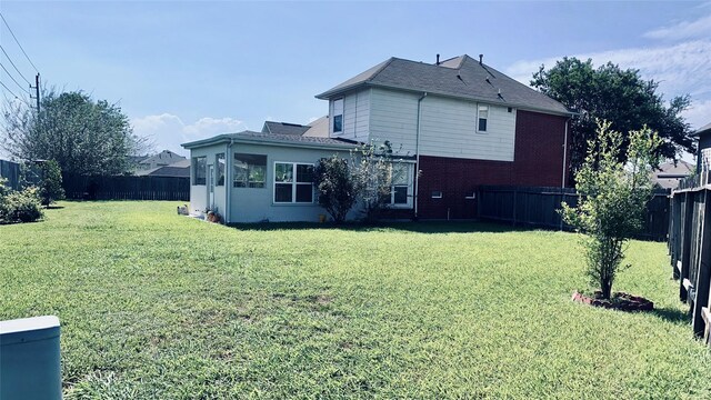 rear view of house with a yard