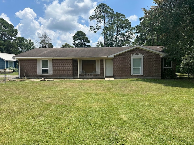 ranch-style home featuring a front yard