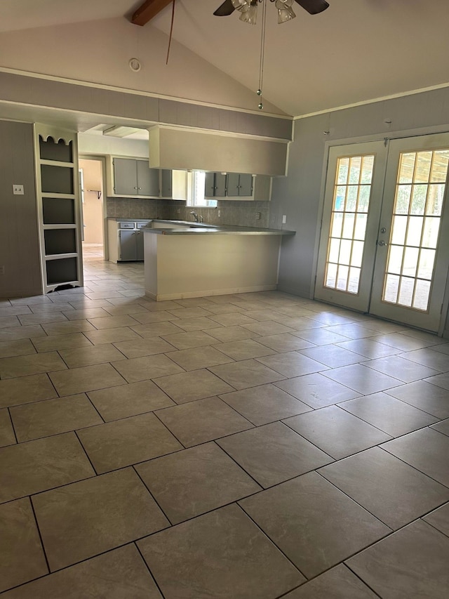 kitchen featuring french doors, lofted ceiling with beams, ceiling fan, decorative backsplash, and kitchen peninsula