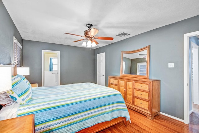 bedroom featuring ceiling fan, a textured ceiling, and light hardwood / wood-style flooring