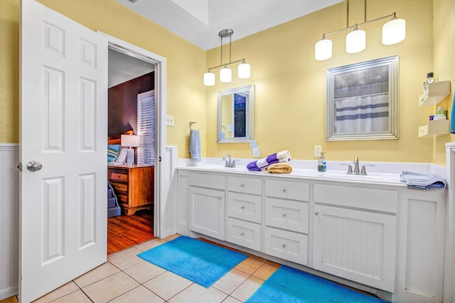 bathroom with a shower with shower curtain, tile patterned flooring, and vanity