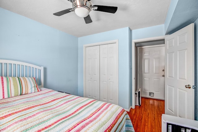 bedroom featuring ceiling fan, a closet, and dark hardwood / wood-style floors