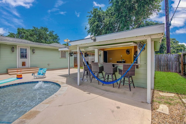 back of property featuring a patio area and an outdoor bar