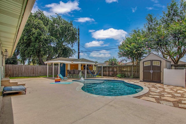 view of pool with a shed and a patio