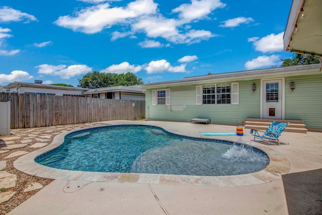 view of swimming pool featuring pool water feature and a patio