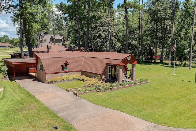 view of front of home with a carport and a front yard