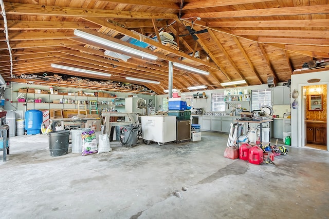 garage with wooden ceiling and a workshop area