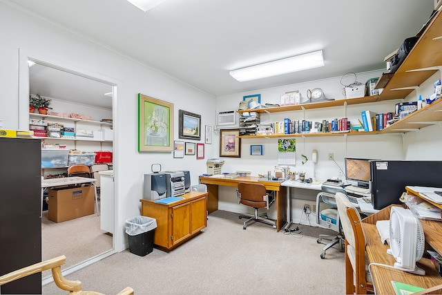 carpeted office with built in desk and a wall mounted AC