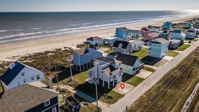 drone / aerial view featuring a water view and a beach view