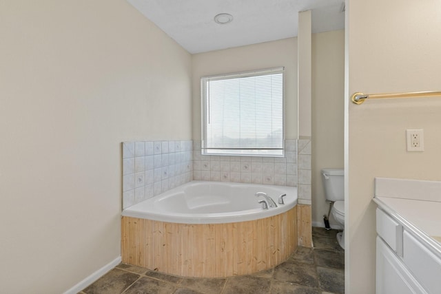 bathroom featuring a tub to relax in, toilet, and vanity