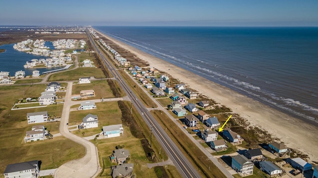 birds eye view of property with a beach view and a water view