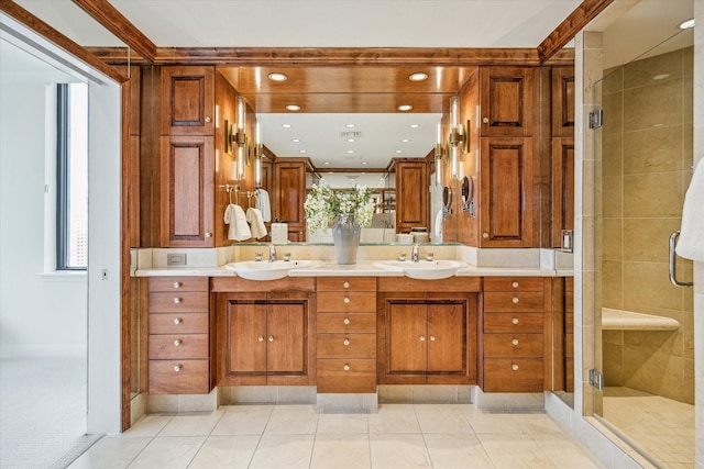 bathroom with tile patterned flooring, a shower with shower door, ornamental molding, and vanity