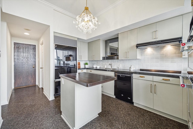 kitchen featuring sink, cooktop, decorative backsplash, a kitchen island, and ornamental molding