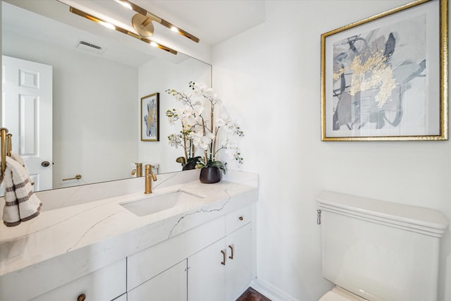 bathroom with vanity and toilet