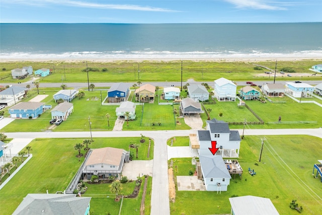 birds eye view of property with a water view, a view of the beach, and a residential view