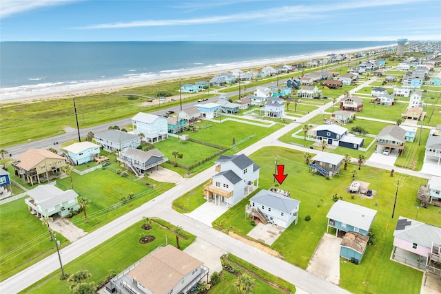 aerial view featuring a residential view, a water view, and a beach view