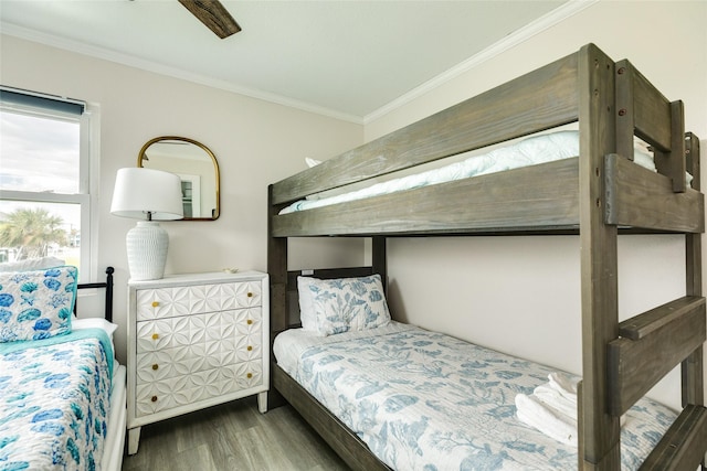 bedroom featuring wood finished floors and crown molding