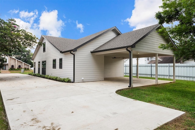 129 S Grace St, Crockett, TX 75835 - view of side of property featuring a shingled roof, concrete driveway, and a carport