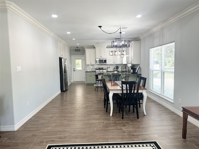 129 S Grace St, Crockett, TX 75835 - dining room featuring baseboards, ornamental molding, a chandelier, dark wood-type flooring, and recessed lighting