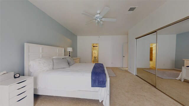 carpeted bedroom with ceiling fan and a closet