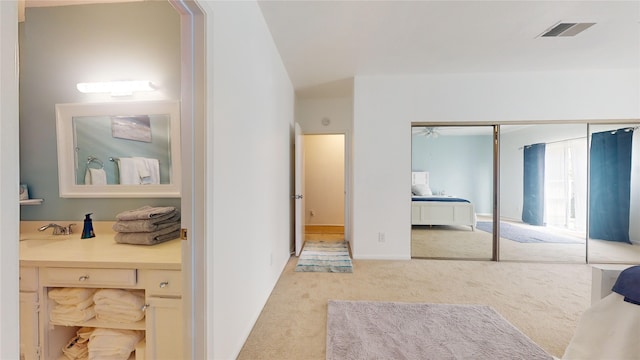 bathroom with lofted ceiling and vanity