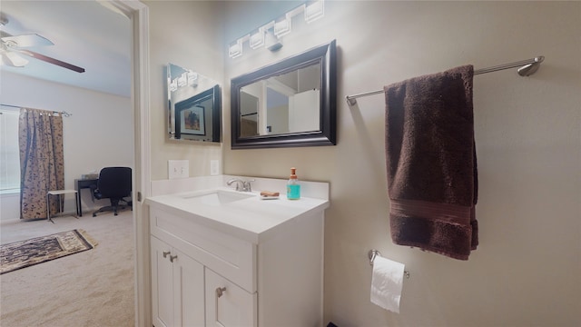 bathroom featuring ceiling fan and vanity with extensive cabinet space