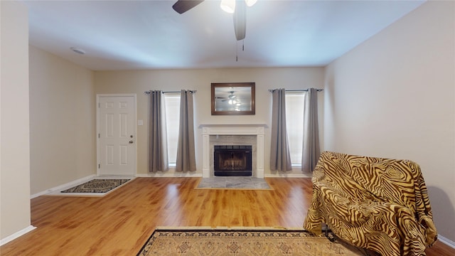 unfurnished living room featuring ceiling fan, a fireplace, and hardwood / wood-style flooring