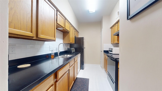 kitchen with black appliances, sink, backsplash, and light tile floors