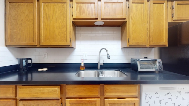 kitchen featuring sink and tasteful backsplash