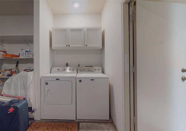 laundry area featuring cabinets, hookup for an electric dryer, and washing machine and clothes dryer