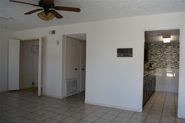 unfurnished room featuring ceiling fan and light tile patterned flooring