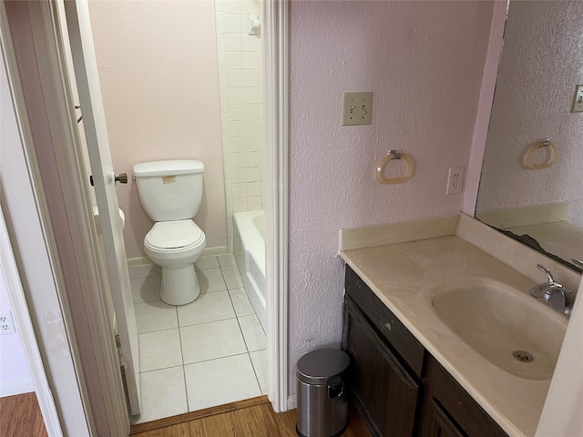 bathroom featuring tile patterned floors, vanity, and toilet