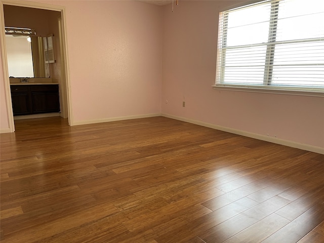 unfurnished room with wood-type flooring