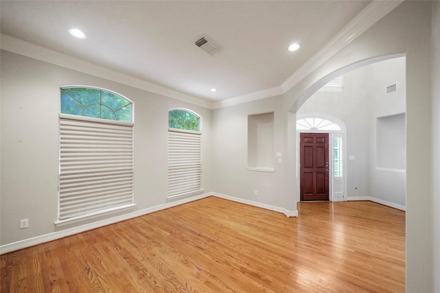 interior space with light hardwood / wood-style floors and crown molding