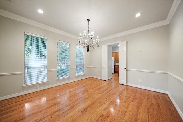 unfurnished dining area with light hardwood / wood-style floors, a notable chandelier, and ornamental molding