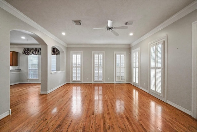 unfurnished room featuring ceiling fan, ornamental molding, and light hardwood / wood-style flooring