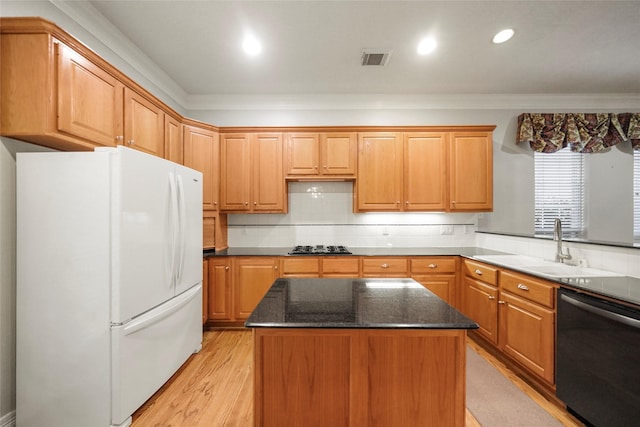 kitchen featuring a center island, white refrigerator, sink, light hardwood / wood-style flooring, and stainless steel dishwasher