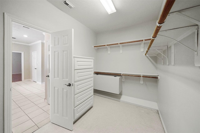 walk in closet with light tile patterned flooring