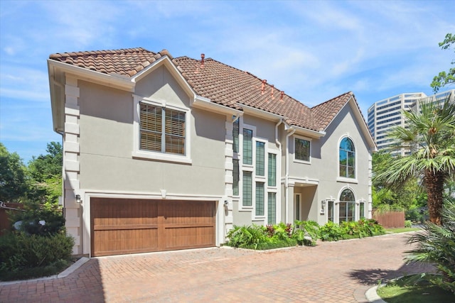 mediterranean / spanish-style house with a garage