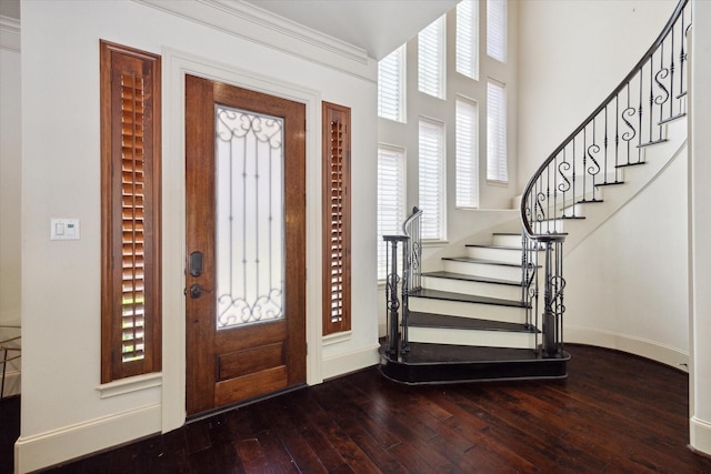 entrance foyer featuring hardwood / wood-style flooring and crown molding