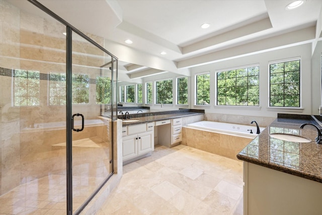 bathroom featuring shower with separate bathtub, vanity, and a tray ceiling