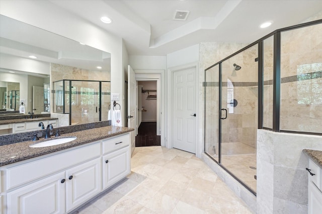 bathroom featuring vanity and an enclosed shower