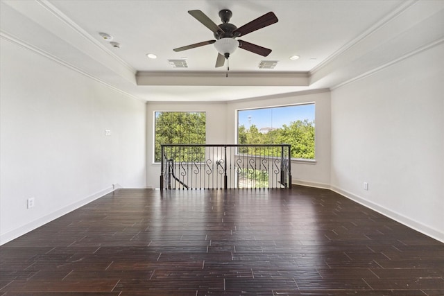 unfurnished room with a tray ceiling, ceiling fan, and ornamental molding