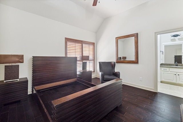 bedroom with dark hardwood / wood-style flooring, ensuite bathroom, ceiling fan, sink, and lofted ceiling