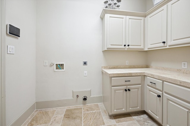 clothes washing area with cabinets, hookup for a washing machine, hookup for a gas dryer, and electric dryer hookup