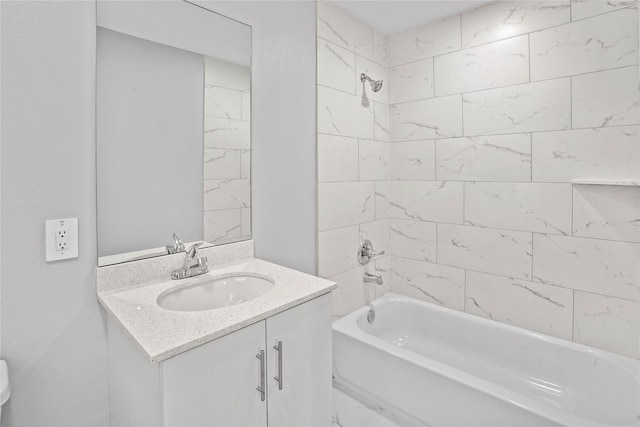 bathroom featuring vanity and tiled shower / bath