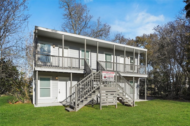 rear view of property featuring a lawn