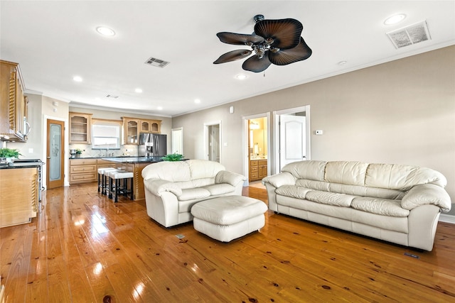 living room with ceiling fan and light wood-type flooring