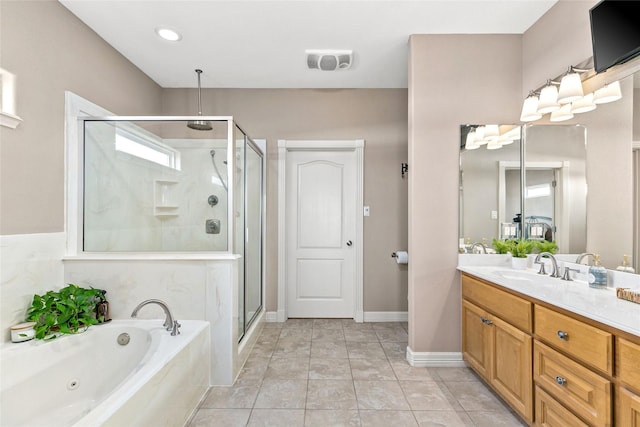 bathroom with tile patterned floors, vanity, and separate shower and tub